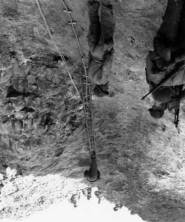 U.S. Rangers climbing the 100 ft cliffs at Pointe De Hoc The assault began before the main landing to knock out German Guns at the top of the Cliff. Two U.S. Navy Destroyers gave support, Rockets were fired to get ropes atop the cliffs.