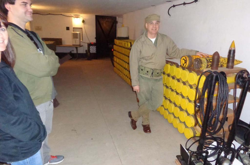 Joel Gonzalez provides information to visitors on the ammunition storage function within the magazine.
