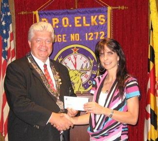 Pleasant Thoughts Page 3 Elks Donation Missy LeCompte, Activity Coordinator of Medical Adult Day Care accepts a check from Gage Thomas, Board Chair of the Cambridge Elks #1272.