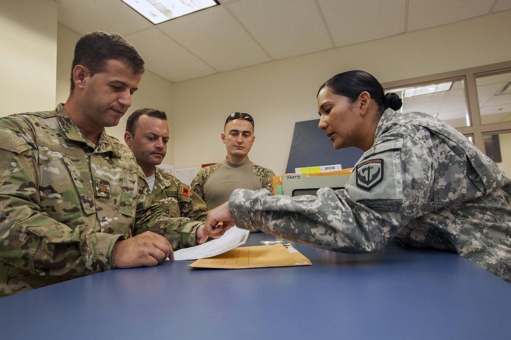 Staff Sgt. Juana E. Garrett, right, Headquarters, 117th Combat Sustainment Support Battalion, explains how a work order is written up to Albanian Armed Forces logisticians Maj.