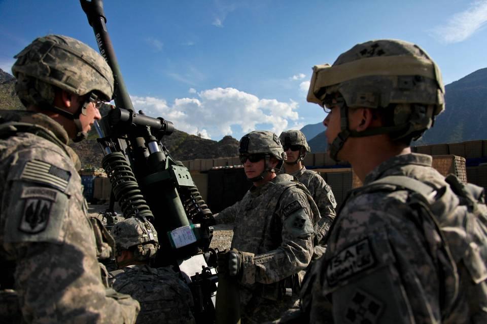 U.S. Army Soldiers assigned to Bravo Company, 2nd Battalion, 77th Field Artillery Regiment, 4th Brigade Combat Team, 4th Infantry Division, wait for orders to fire an M119 light-tow