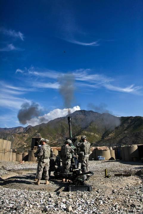 U.S. Army Soldiers assigned to Bravo Company, 2nd Battalion, 77th Field Artillery Regiment, 4th Brigade Combat Team, 4th Infantry Division, fire a 105 mm round with an M119