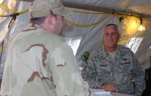 The hub of ECES Air Force Senior Master Sgt. Tommy Morrow talks with a customer at the work control tent at Camp Justice.