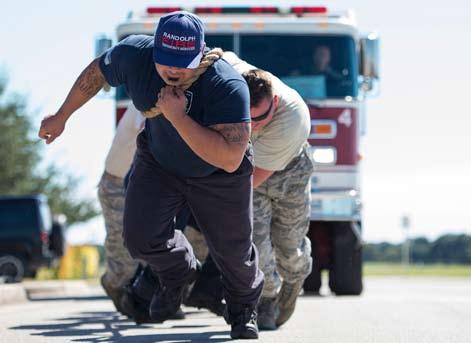 OCTOBER 28, 2016 WNGSPREAD PAGE 5 Battle of the Badges: Fire Dawgs vs Defenders Photo by Airman 1st Class Lauren Ely Members of Joint Base San Antonio-Randolph Fire Emergency Services perform a fire