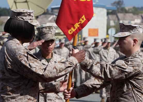 Everly, (left), incoming commanding officer, Communications Company, Combat Logistics Regiment 17, 1st Marine Logistics Group, takes the company guidon from Capt. Jason M.