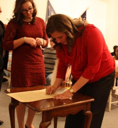 Page 3 Ashley Perry signing the Declaration of Independence at the Vespers/Signing Ceremony.