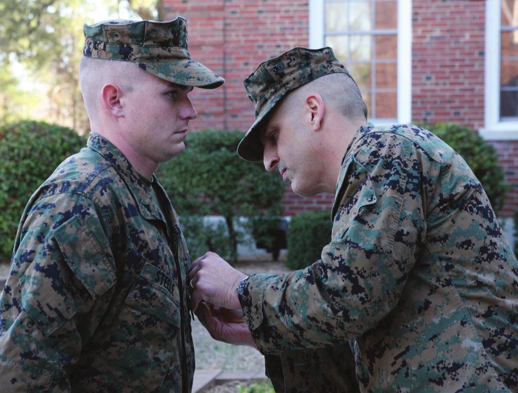 Page 3 Photo by Lance Cpl. Brian Steele (Left), receives the Purple Heart medal from Brig. Gen.