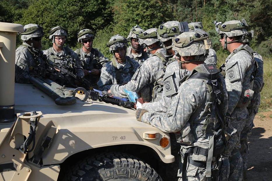 Figure 5. Fourth Platoon executes a mission briefing on the hood of a truck before moving out during Operation Swift Response 2015 in Germany. (Photo by SSG Javier O. Orona) Figure 6.