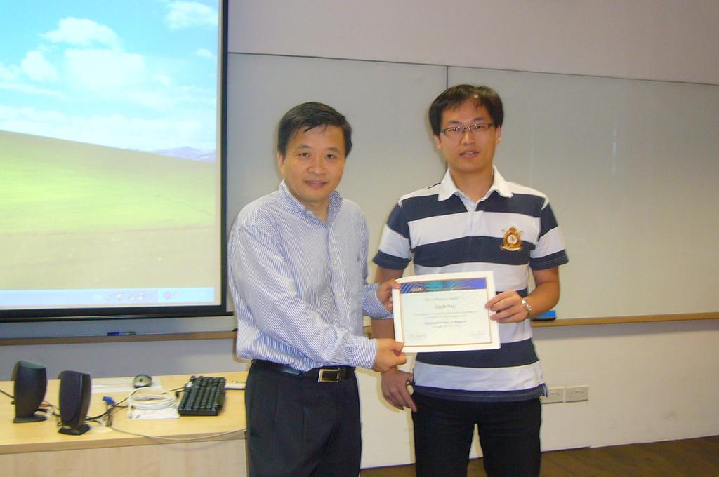 Certificate of Recognition went to Qinglin Tang (right) by Professor Zuowei Shen, Head of Department of
