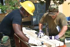 Jhon Mosquera (left) and Pfc. Ilija Marakovic - a Croatian soldier work at sanding the slats to be used on the benches at the playground.