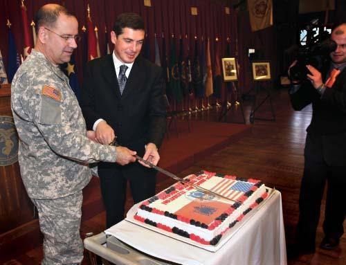 Gazmend Oketa (right), Minister of Defense, Republic of Albania cut a special anniversary cake commemorating the 15-year partnership between New Jersey and the Republic of Albania.