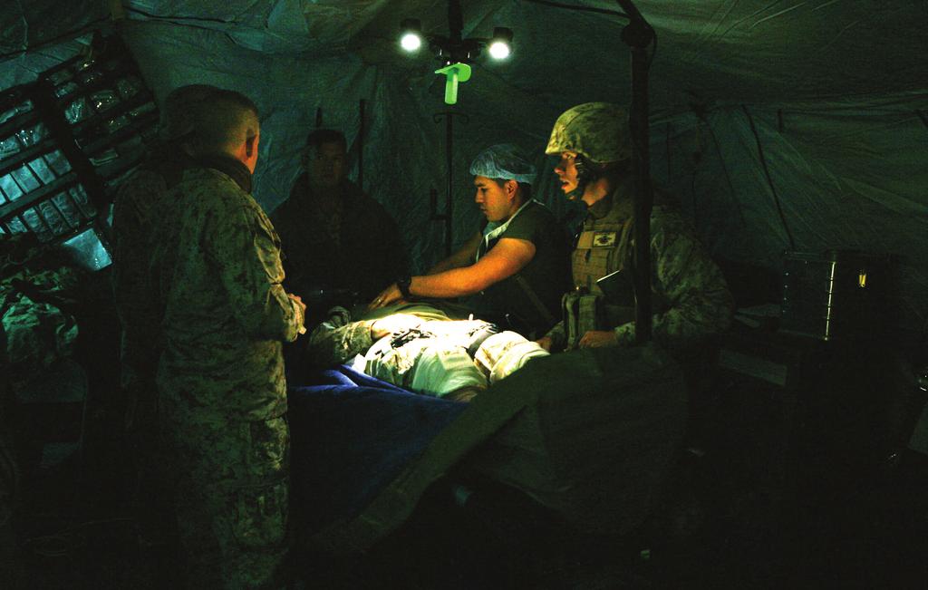 Page 2 Sailors with 2nd Medical Battalion, Combat Logistics Regiment 25, 2nd Marine Logistics Group perform surgery on a simulated patient during a field exercise at Landing Zone Lark aboard Camp
