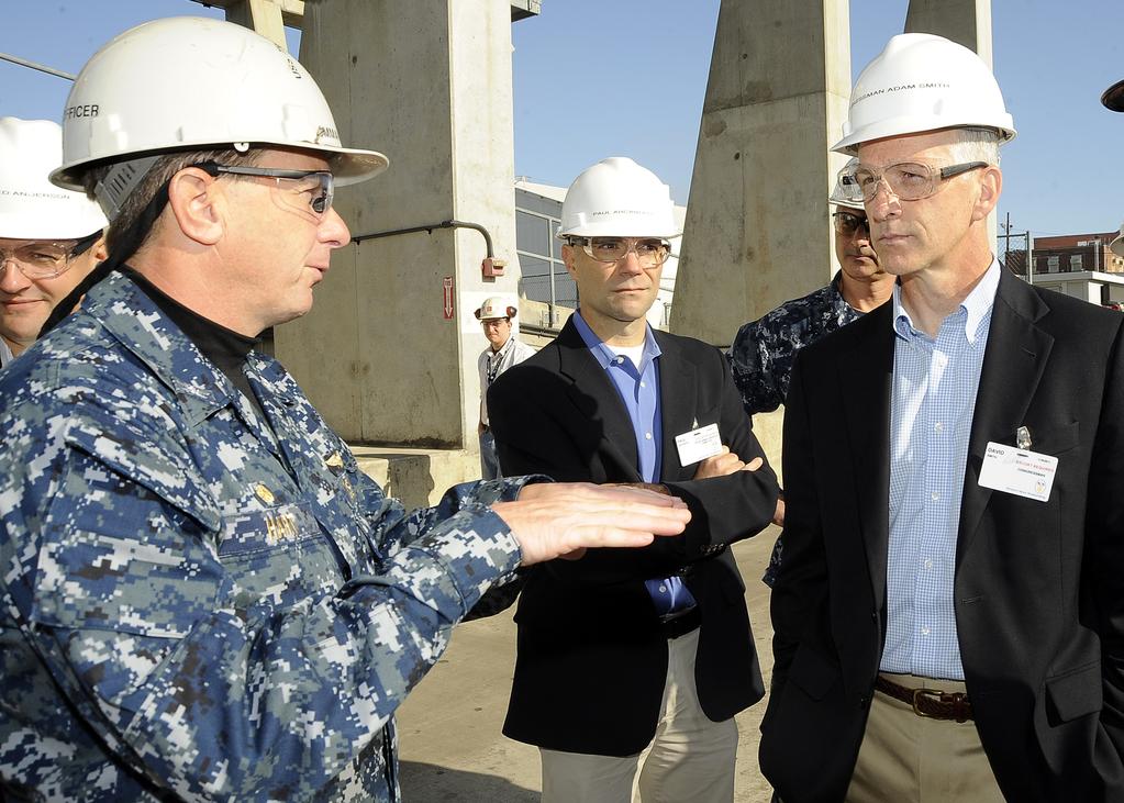 Hart, commanding officer of USS Theodore Roosevelt (CVN 71), gives Congressman Adam Smith (WA) a brief regarding the ship s RCOH as part of a general orientation tour of Huntington Ingalls Industries