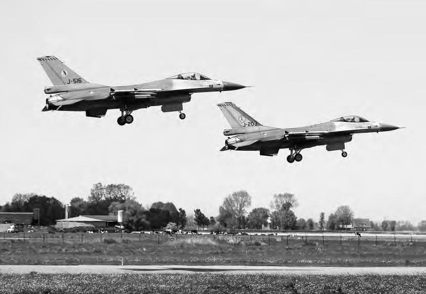 A CENTURY OF MILITARY AVIATION IN THE NETHERLANDS, 1911-2011 221 Two F-16s land at Leeuwarden Air Base. The fighter Squadrons 322 and 323 have been stationed at Leeuwarden for several decades.