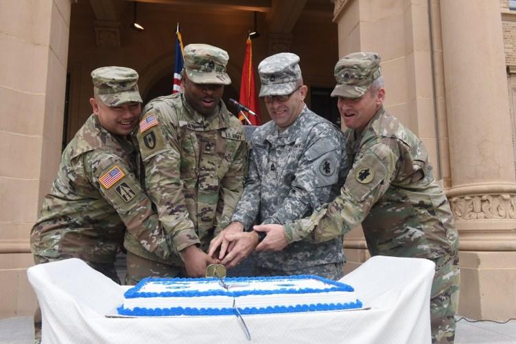 Brig. Gen. James P. Wong (left) leads the traditional cake-cutting as U.S.