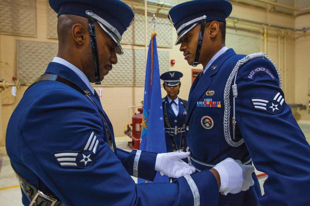 Final Check Senior Airman Vaughn Price, left, makes a final adjustment on Senior Airman Guss Tyshawn Jenkins uniform prior to the 108th Contingency Response Group s Assumption of Command ceremony at
