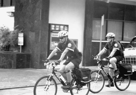 BICYCLE PATROL Hilo Community Policing Officers Van Reyes, in front, and Jason Shinoda, patrol the streets of downtown Hilo on their bicycles.