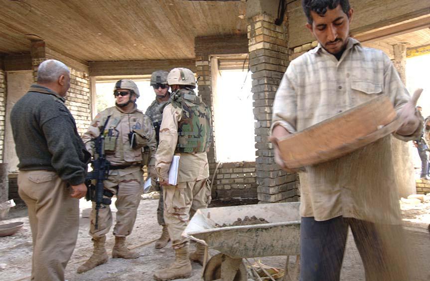 Major Operations and Campaigns An Iraqi construction worker sifts building materials in Taji, Iraq, while soldiers from the 490th Civil Affairs Battalion discuss the project with the construction