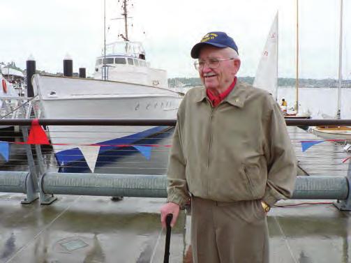 Right: In 2005, the late Wilfred Bud Eberhart, a WWII Coast Guard Signalman 3rd class, stood proudly in front of the very patrol boat he was aboard during the historic invasion at Normandy, France on