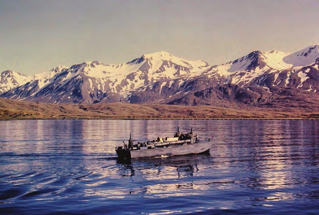 Top: A solitary Navy Higgins PT (patrol torpedo) boat moves slow ahead in icy blue Alaskan waters off Attu Island during WWII.