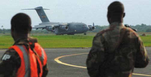 USAF photo by MSgt. Brian Bahret Liberian soldiers provide security as a USAF C-17 arrives to take members of their service to Mali.
