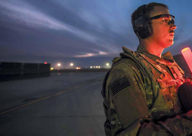 SSgt. Michael Finney marshals an F-16 on a runway in Southwest Asia in November. Air Force Chief of Staff Gen.