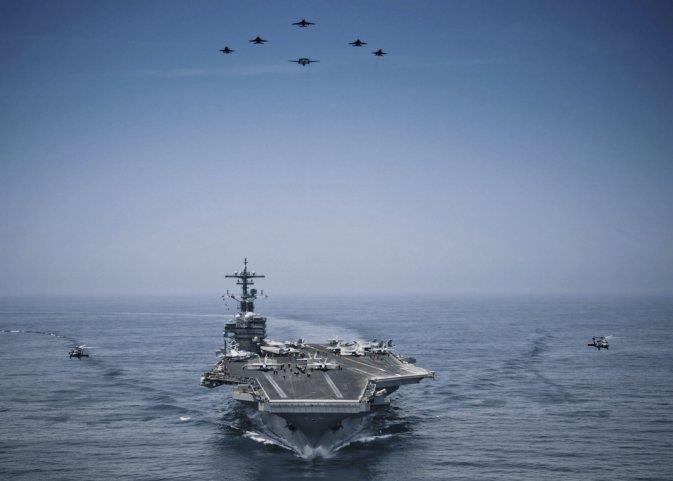 Aircraft from Carrier Air Wing 8 fly in formation over the Nimitz-class aircraft carrier USS George H W Bush (CVN 77) in the Arabian Sea on 29 April 2014.