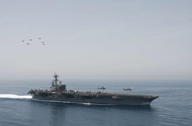 Aircraft from Carrier Air Wing 8 fly in formation over the Nimitz-class aircraft carrier USS George H W Bush (CVN 77) during a photo exercise in the Arabian Sea on 29 April 2014.