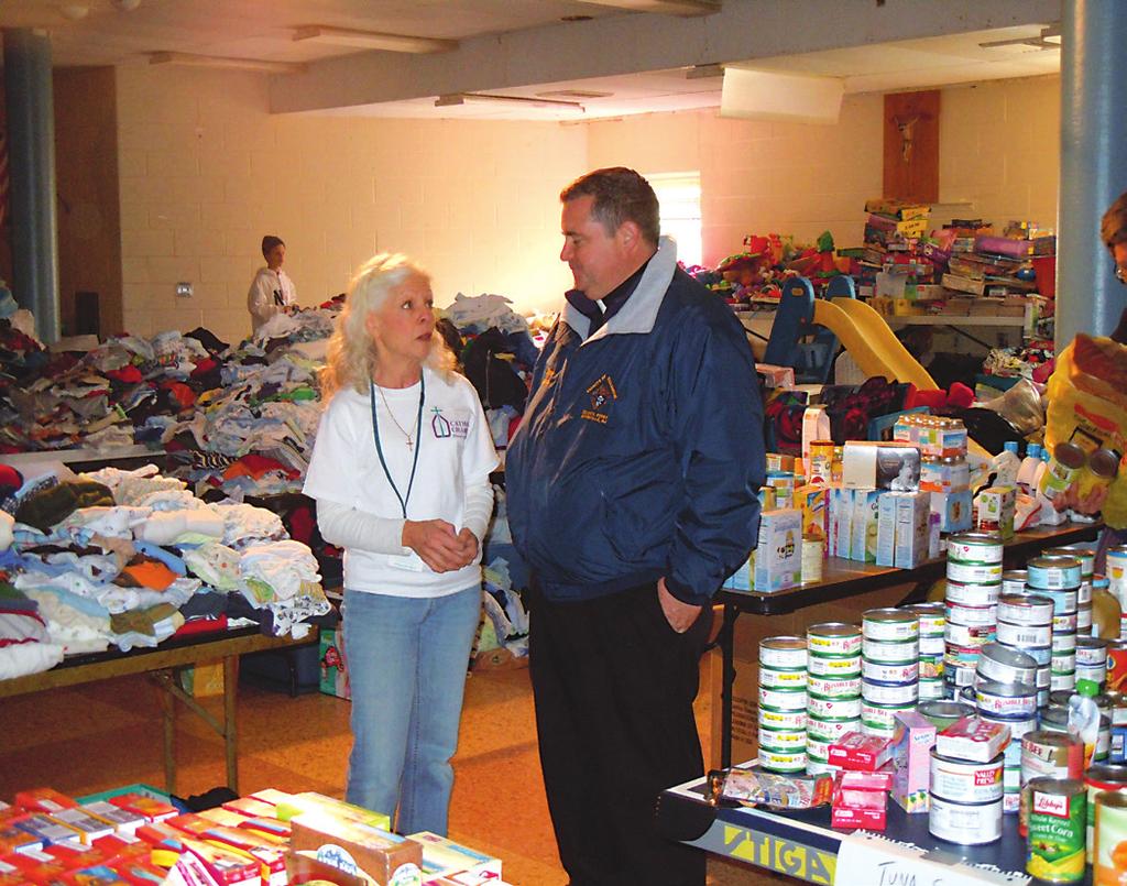 Above, Maria Hunter, director, Office of Parish Social Ministry, Catholic Charities, and Father Thomas F. Ryan, pastor of Our Lady of Victories Parish, Sayreville, aided those hard hit.