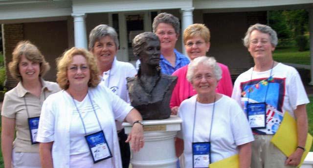 PAGE 6 Participants in the Associates Conference surround a statue of Catherine McAuley at Georgian Court University.