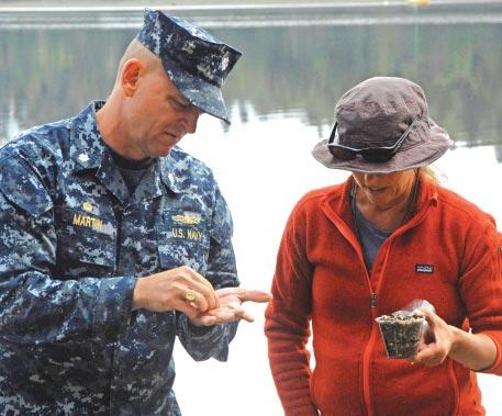 Viviane Barry, shellfish program manager for the Suquamish Tribe Fisheries Department, shares her subject matter expertise with Cmdr. Gary Martin, NAVMAG Indian Island commanding officer.