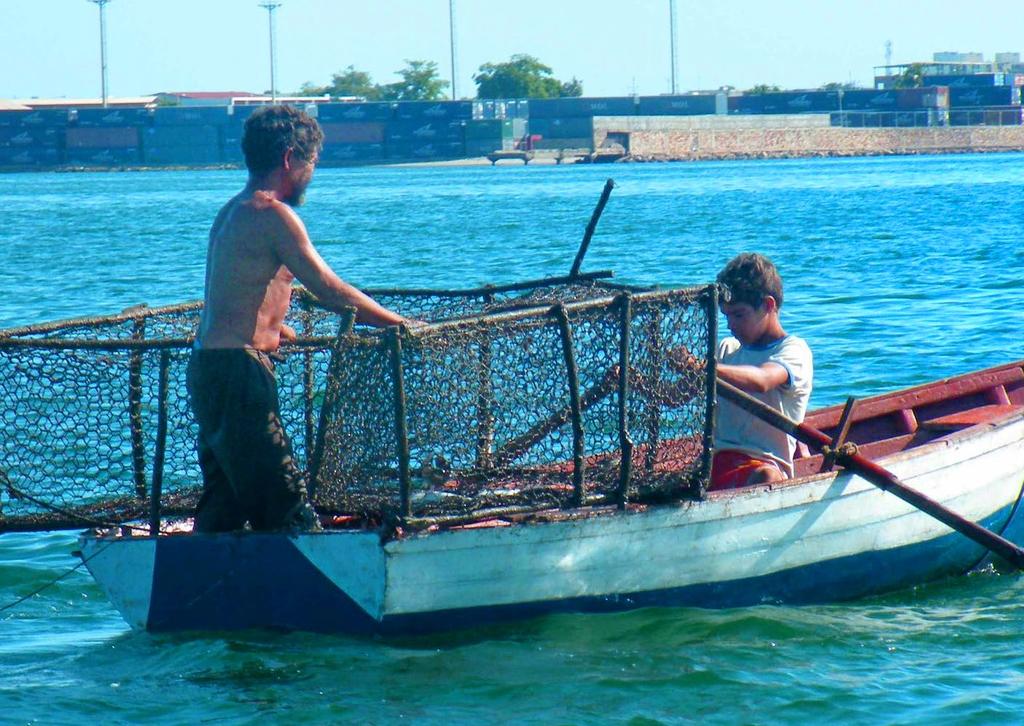 A fisher and his young assistant in Cumaná, Venezuela, location of the 62nd GCFI. Photo: R.Glazer, 2009 GCFI also hosts the Invasive Lionfish web portal.