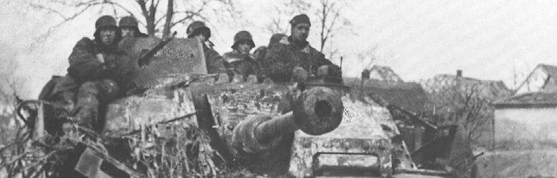 German reinforcements ride on the hull of a Sturmgeschutze Stug III self propelled gun during a counterattack into the Huertgen Forest, early November, 1944.