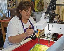The industrial-size machine sews together the quilt sandwich of top, batting and backing.