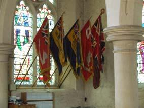 (Right: Royal Canadian Legion flags amongst others adorn the interior of St. Mary s Church in the English village of Bramshott.