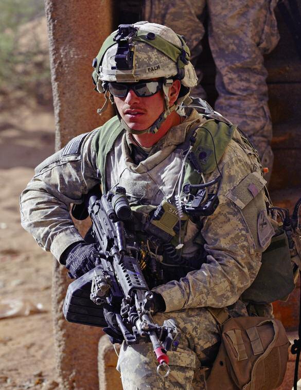 SPC Eric Palm, Squad Automatic Weapon gunner with the 2nd BCT, 1st Armored Division, defends his position after a cordon and search of Palmiyah Village, part of the training area at Fort Bliss, Texas.