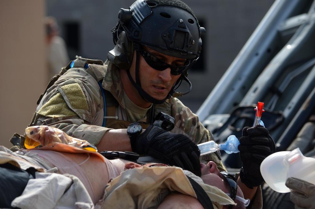 MSgt. Christopher Lais, 308th Rescue Squadron, administers care to a vehicle-borne improvised explosive victim during a mass casualty training exercise conducted March 10, 2015 in Perry, GA.