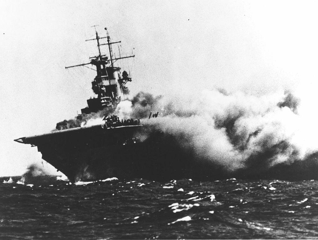 The U.S. Navy aircraft carrier USS Wasp (CV-7) burning and listing after she was torpedoed by the Japanese submarine I-19, on Sept.