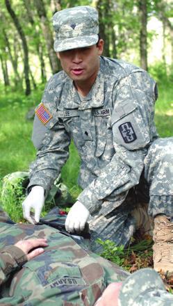 SPC Andrew Lee, a medic with the 325th Combat Support Hospital, applies a tourniquet to a wounded leg during the Army Reserve s Global Medic Exercise.