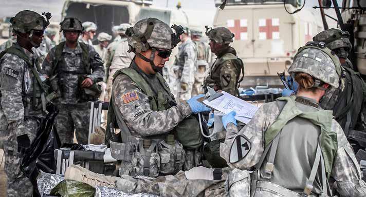 Medics treat simulated casualties at the 115th Brigade Support Battalion s aid station during a mass casualty exercise at the National Training Center, on Oct. 14, 2015. (Photo by Staff Sgt.