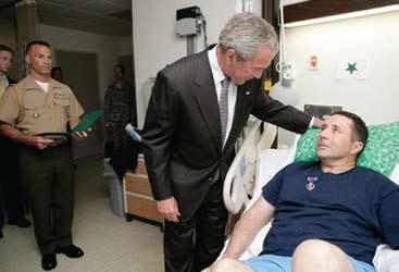 where two wounded soldiers were awarded Purple Hearts by General Colin L. Powell (Ret.). Maj.