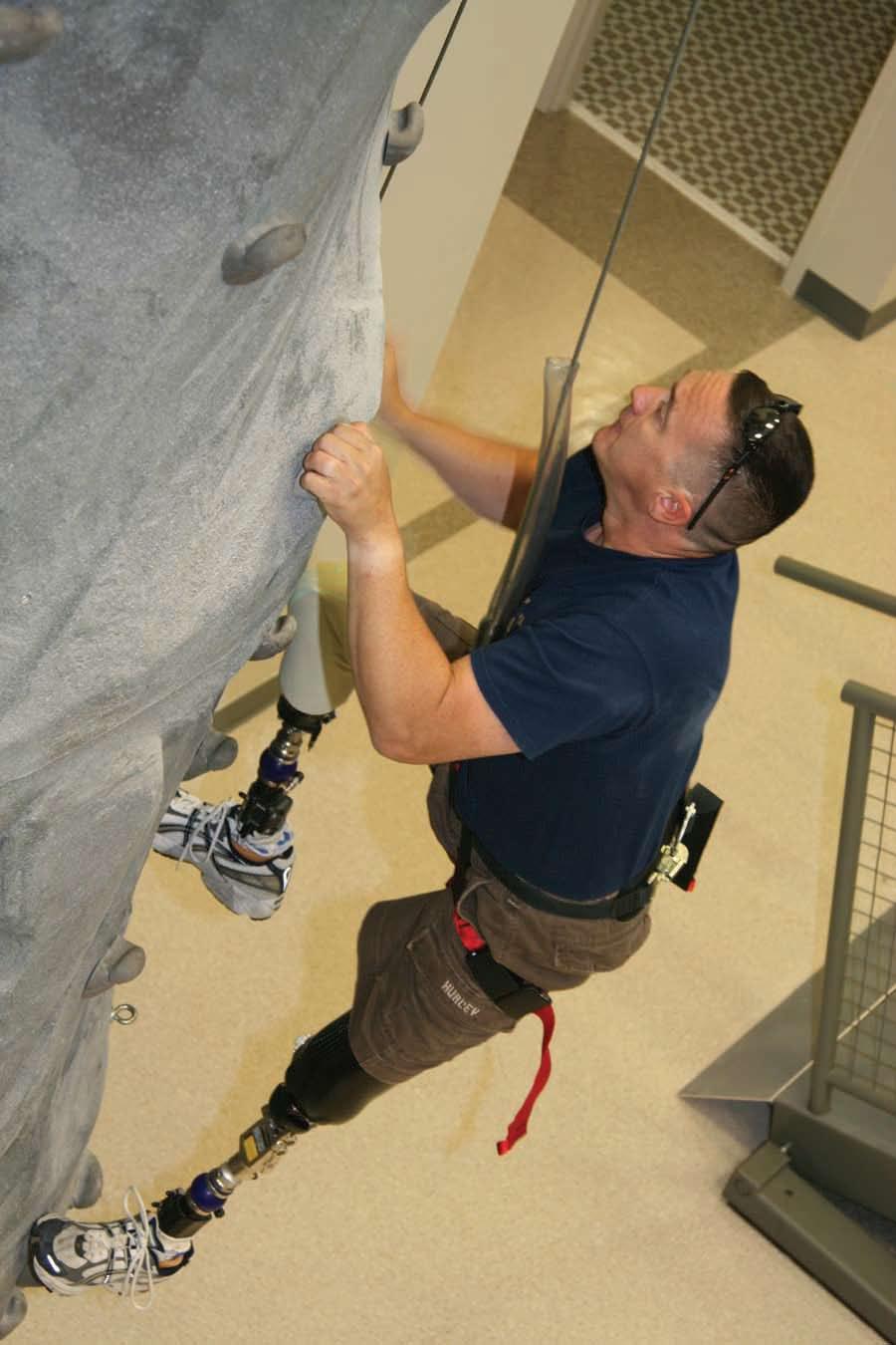 276 A soldier practices climbing skill on the rock wall located in the Military