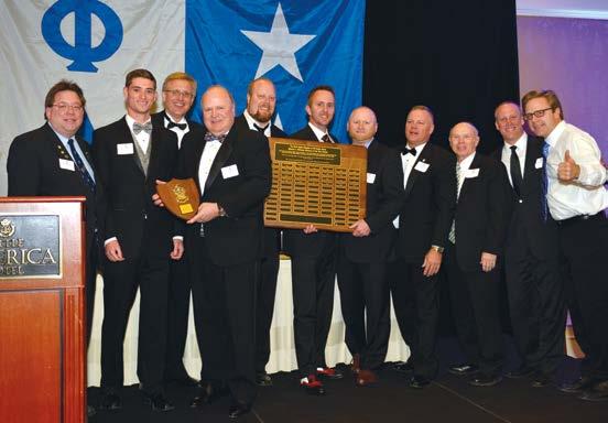 Carl E. Mergele, 85 pictured in center holding small personal plaque was recognized with the chapter s Utah Alpha Alumnus of the Year Award.