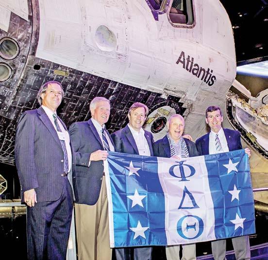 Brothers Will Graves, Jon McBride, Michael R. Rowland, F. Story Musgrave, and Bob Biggs in front of the Space Shuttle Atlantis at the recent Phi Delt Weekend at the Kennedy Space Center.