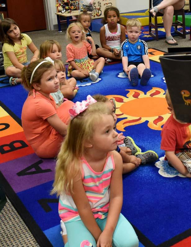 AIR FORCE 6 A group of children listen to Alvina Smith, 4th Force Support Squadron library technician, read during weekly story time, June 13, 2017, at the base library at Seymour Johnson