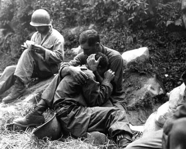 A grief-stricken American infantryman whose buddy has been killed in action is comforted by another Soldier.