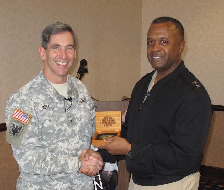 Wolf, director of Army Safety Director, Richard Wright, United States Army Corps of Engineers, with a coin and certificate of appreciation.