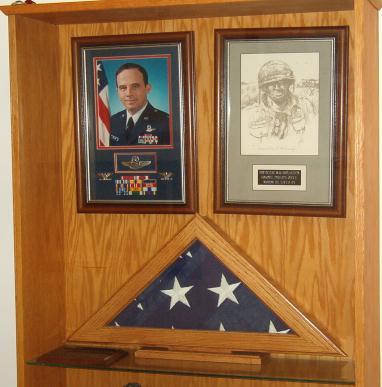 The central display case houses Capt Kaye s uniform, photos of his personal and military life and replicas of his medals.