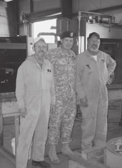 Certified welders Ron Burton (left) and Larry Mitchell flank BG Phillips during his visit to the Pilot Model Shop at Tooele Army Depot, UT.