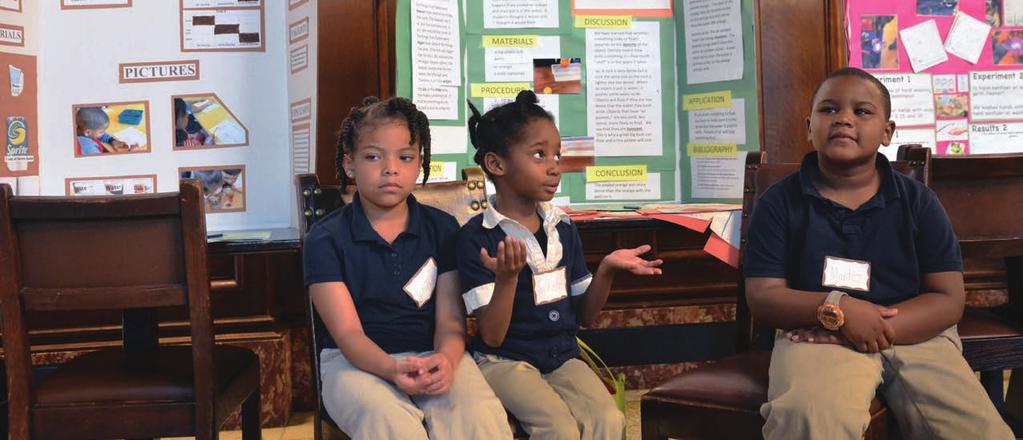Above: From left, kindergartners Nalani, Trishelle and Montez represent their class project, Oranges Should Never Skinny-dip, which analyzed whether oranges float with or without their skins.
